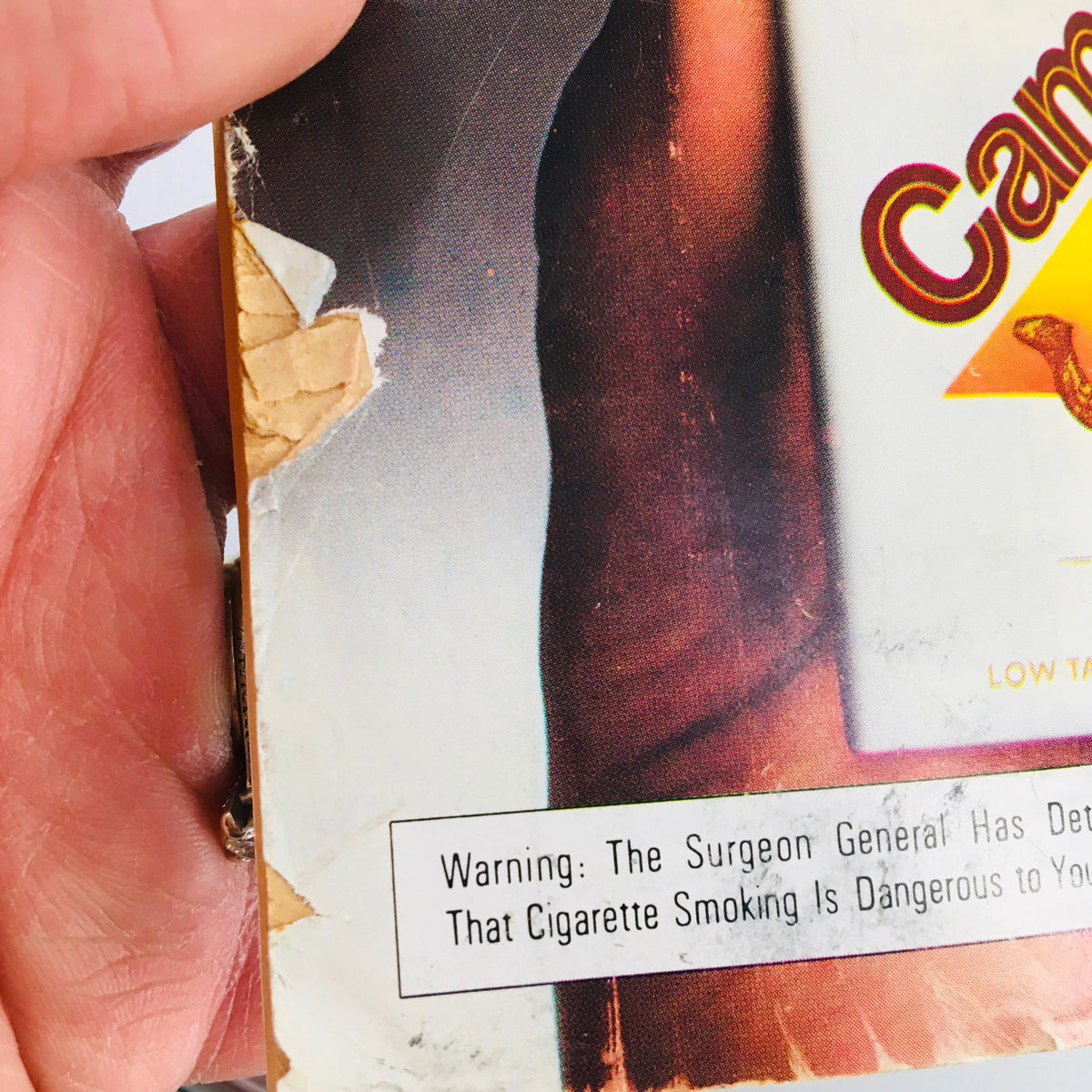 Detail of the back cover of the VTG Baseball Digest Magazine from March 1979, showing signs of wear, including a torn edge and a warning label, emphasizing the magazine's historical significance and vintage appeal.