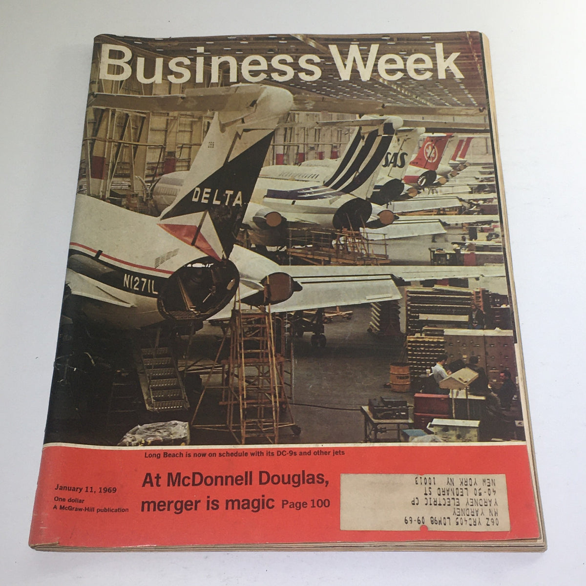 Cover of Business Week Magazine from January 11, 1969 featuring an article about the McDonnell Douglas merger, showcasing aircraft in a hangar, highlighting the historic aerospace industry developments.