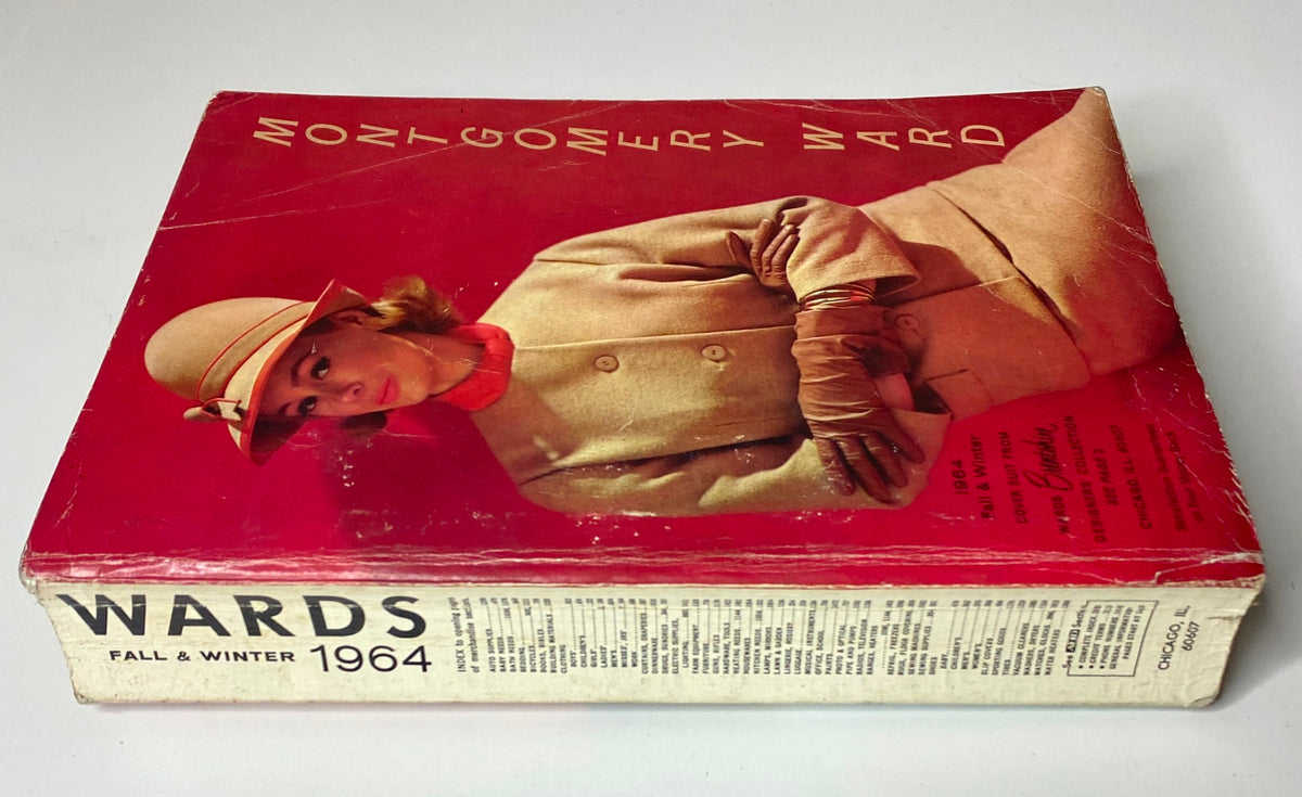 Side view of the 1964 Montgomery Ward Fall and Winter Catalog highlighting the model's vintage outfit and detailing on the cover, including the catalog title and age.