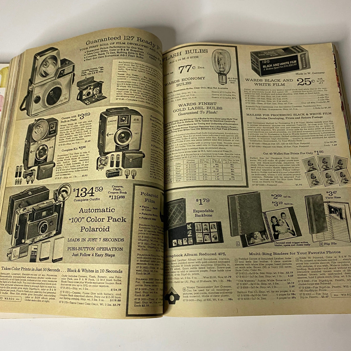 1964 Montgomery Ward Fall and Winter Catalog showcasing camera advertisements, including Polaroid options and black and white film prices.