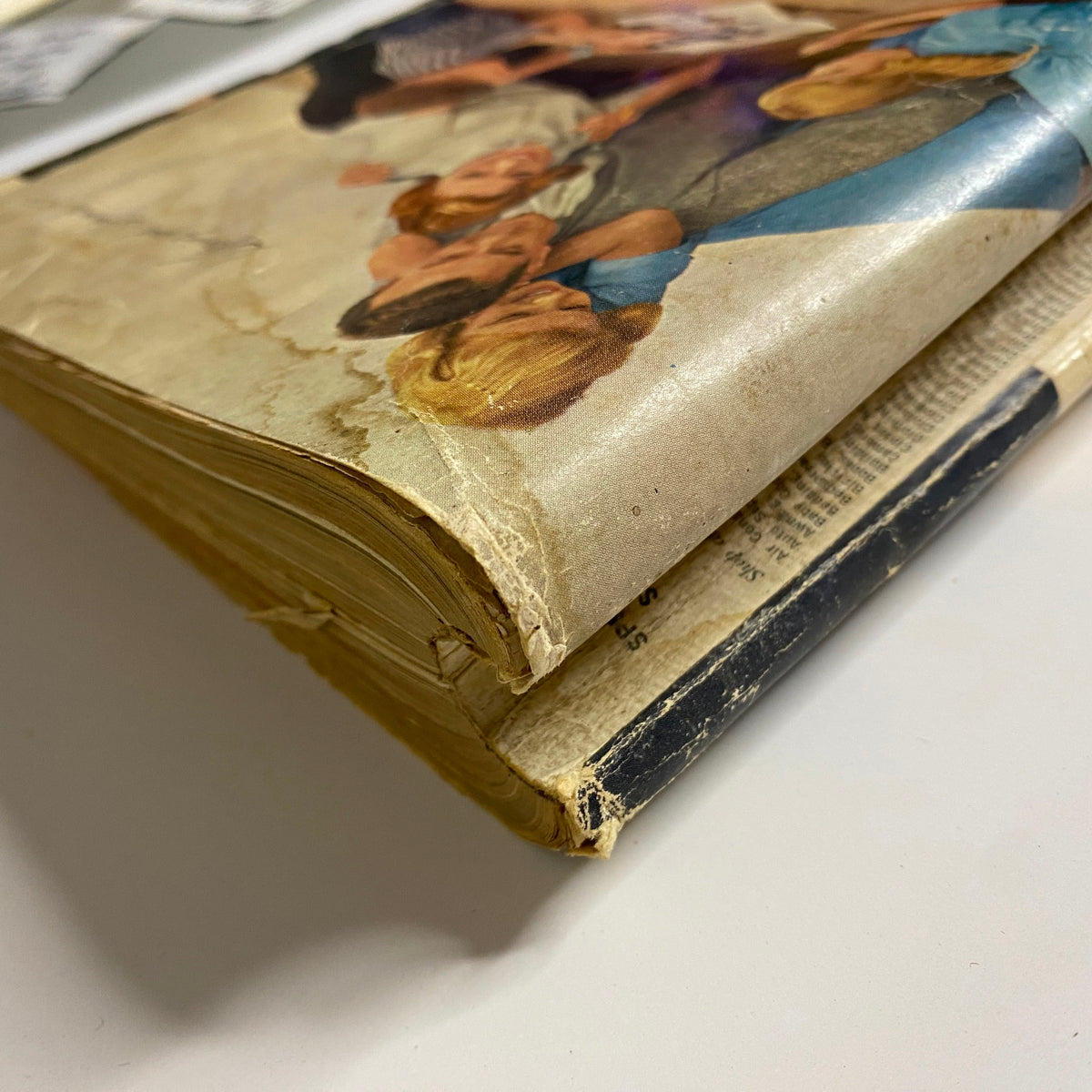 Side view of the 1958 Sears, Roebuck and Co. Spring and Summer Catalog, showcasing vintage worn edges and bound pages, highlighting the collectible nature of the magazine.
