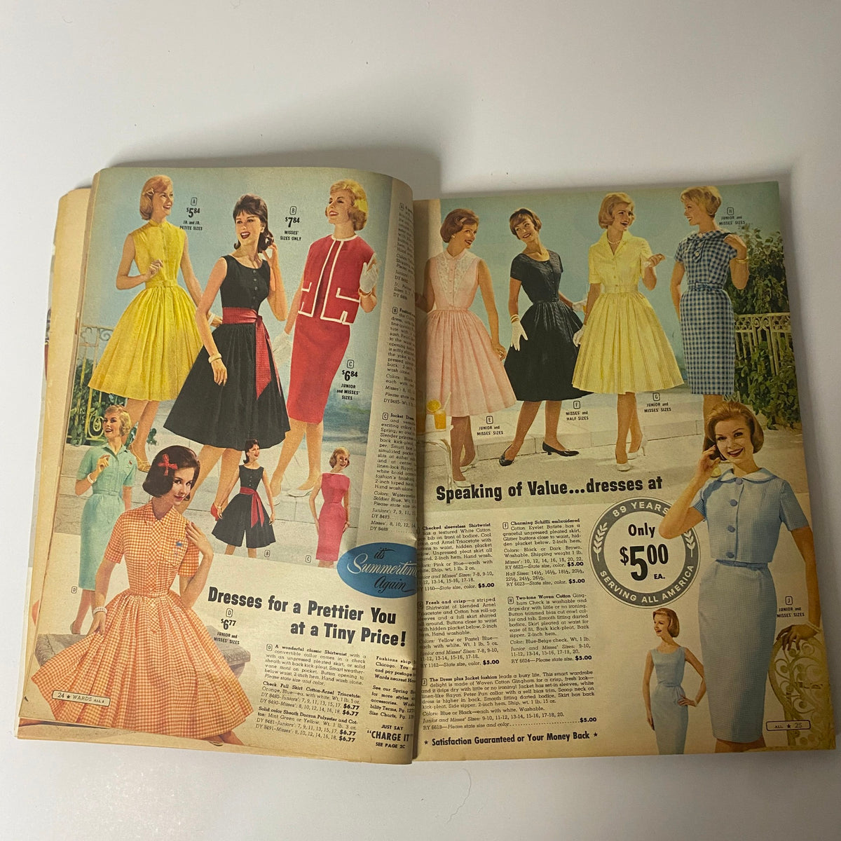 Inside spread of the 1961 Montgomery Ward Summer Catalog featuring a variety of dresses available at affordable prices.