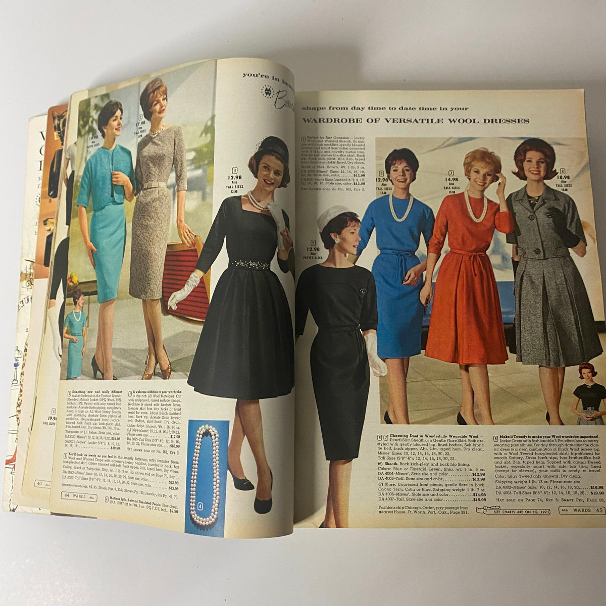 Various versatile wool dresses for women presented in the 1962 Montgomery Ward Fall and Winter Catalog, showcasing chic styles that exemplify early 60s fashion trends for both day and evening wear.