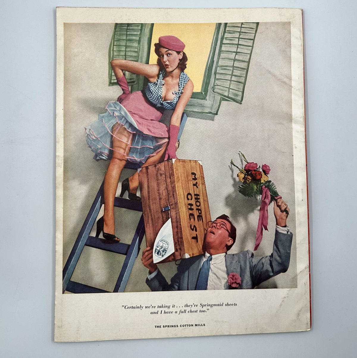 Esquire Magazine March 1955 featuring a humorous pinup image of a woman in a playful outfit, engaging with a man holding a box, promoting Spinning Mills sheets.