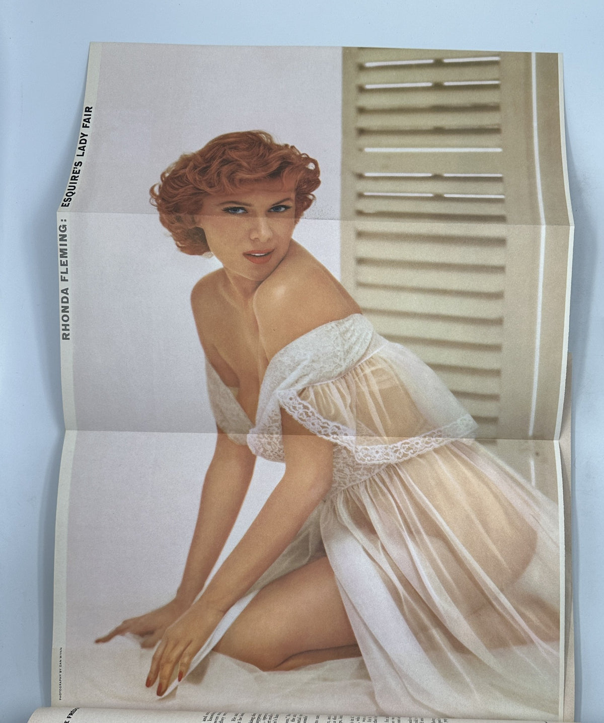 Foldout pinup of Rhonda Fleming from Esquire Magazine December 1955, depicting her in a delicate, sheer outfit. A notable feature of this vintage magazine edition.