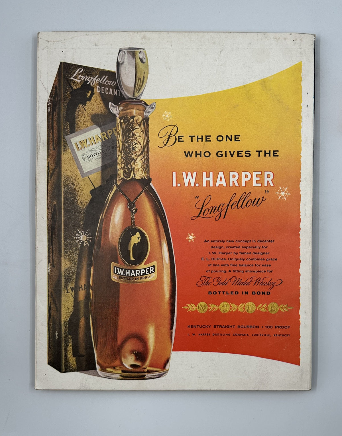 Esquire Magazine December 1955 displaying an advertisement for I.W. Harper bourbon, promoting the Longfellow decanter, beautifully designed for holiday gifting.