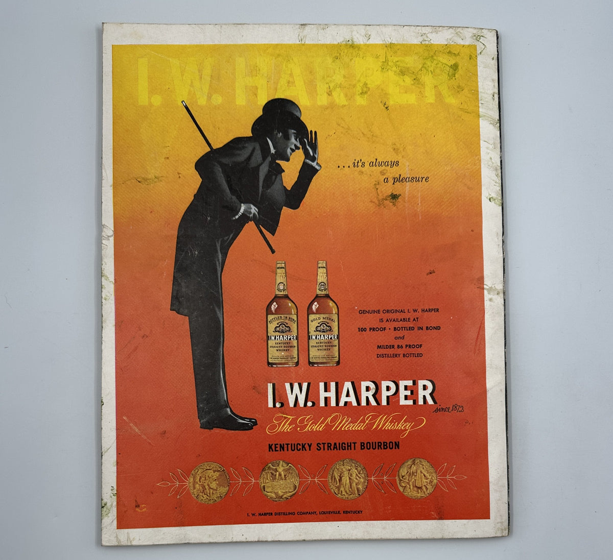 Esquire Magazine October 1955 advertisement for I.W. Harper Kentucky Straight Bourbon, showcasing an elegant man in a suit with bourbon bottles set against a gradient background.