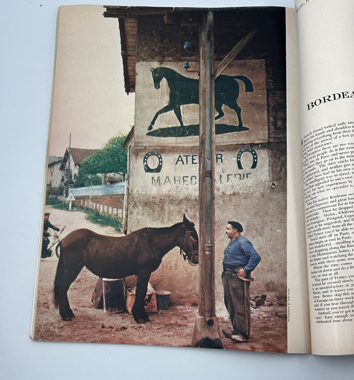Esquire Magazine March 1956 photograph of a man with a horse near a rustic building, highlighting rural life and craftsmanship.