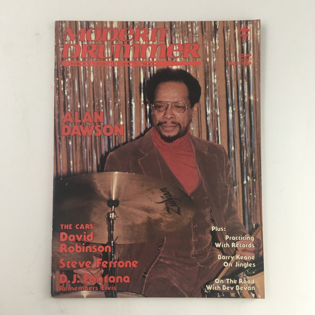 Modern Drummer Magazine from May 1985 featuring Alan Dawson on the cover, highlighting drummers David Robinson and Steve Ferrone, with a vibrant background and details about drumming culture.