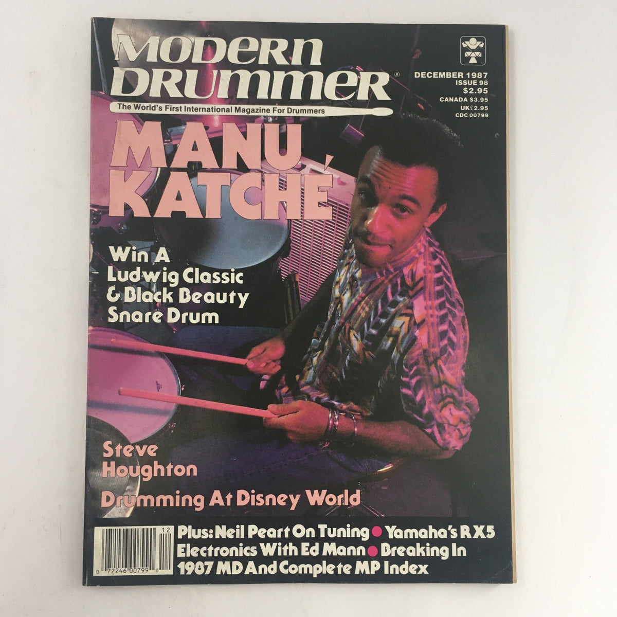 Cover of Modern Drummer Magazine December 1987 featuring drummer Manu Katche, with articles on Steve Houghton and Neil Peart, highlighting the world of drumming.
