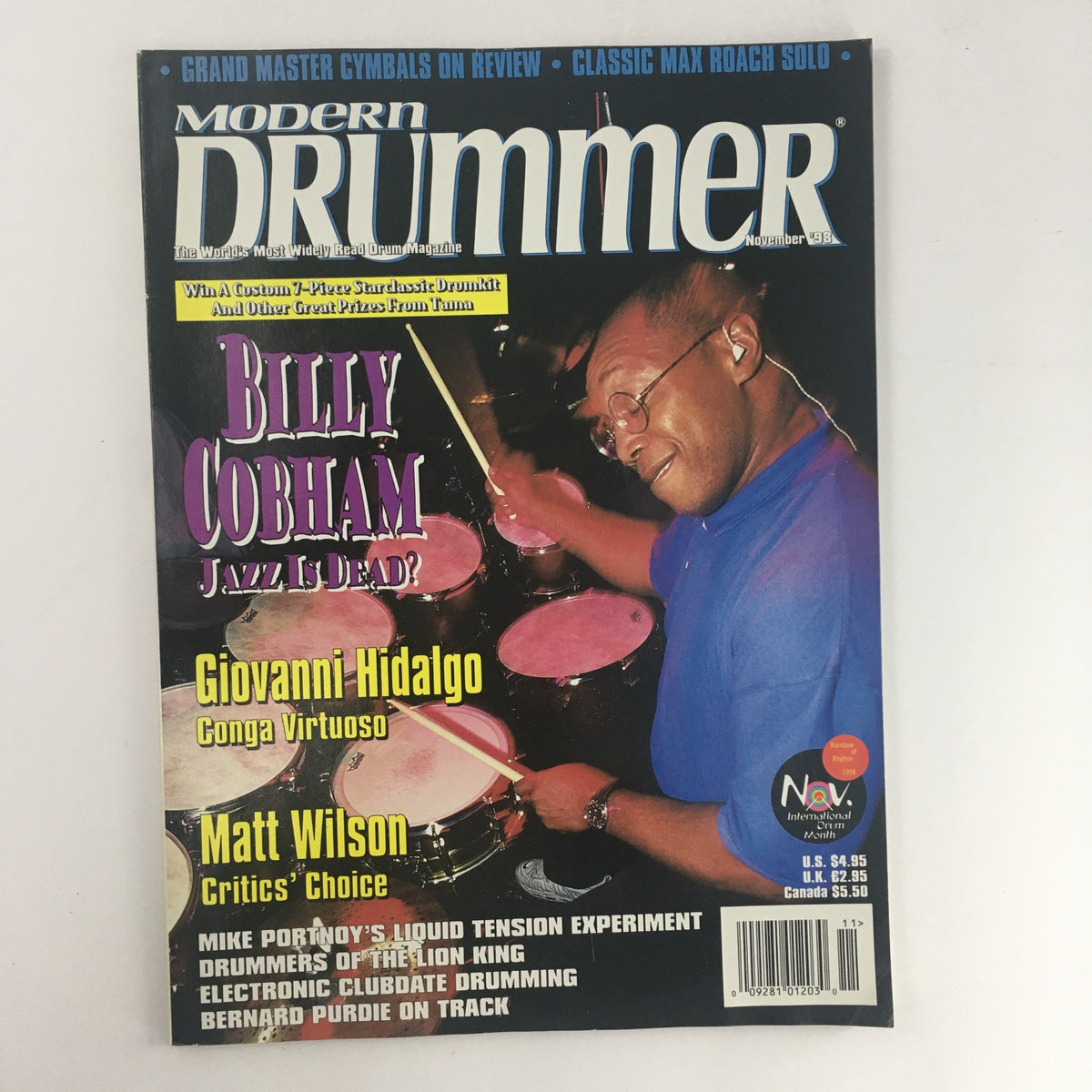 Cover of Modern Drummer Magazine from November 1998 featuring Bill Cobham, Giovanni Hidalgo, and Matt Wilson. The cover highlights the article 'Jazz Is Dead?' by Billy Cobham alongside features on conga virtuoso Giovanni Hidalgo and critic’s choice Matt Wilson. Perfect for vintage magazine collectors and drumming enthusiasts.
