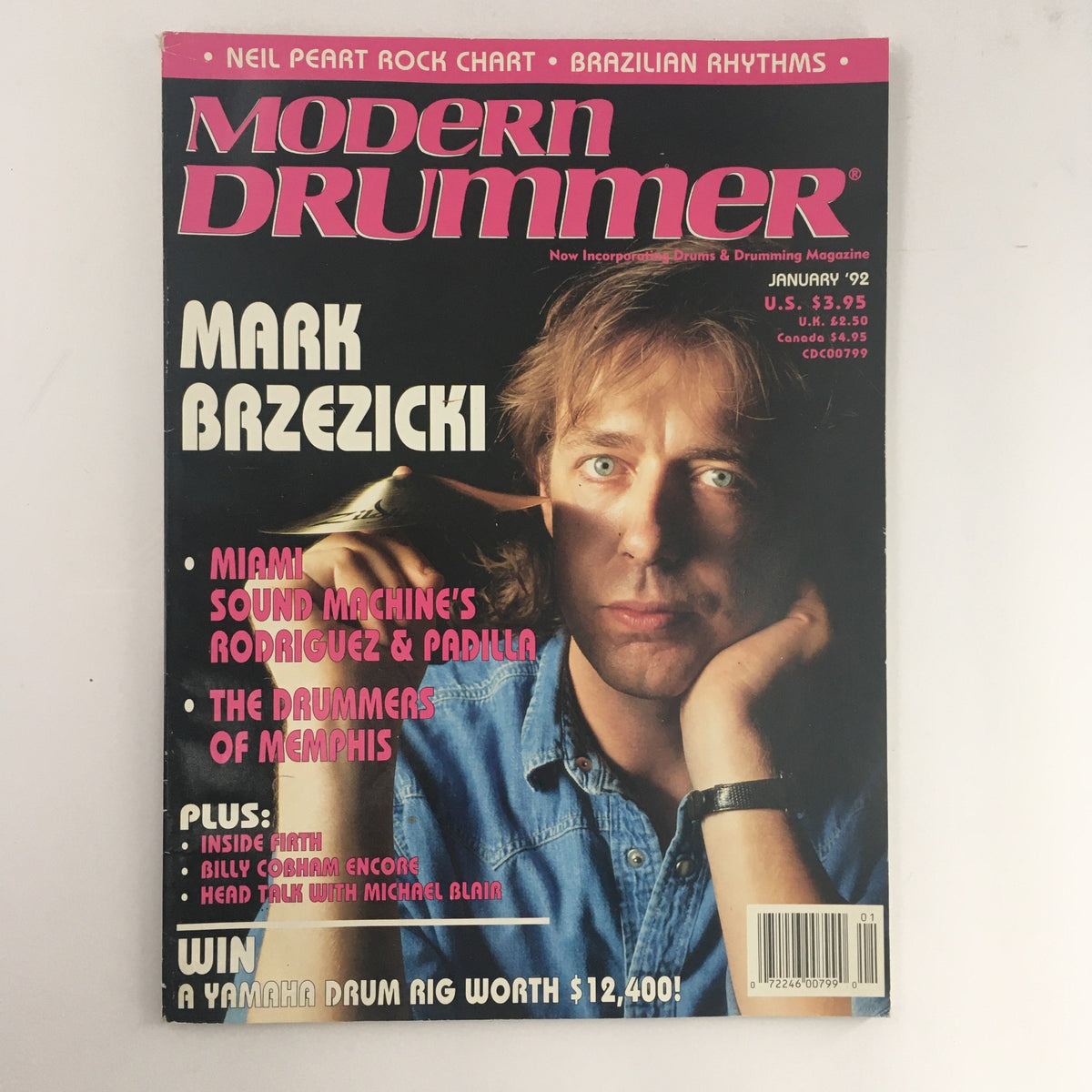 Cover of Modern Drummer Magazine January 1992 featuring Mark Brzezicki. The magazine highlights articles on Neil Peart, Billy Cobham, and various drumming techniques. Eye-catching design with vibrant colors, emphasizing the legends of drumming.