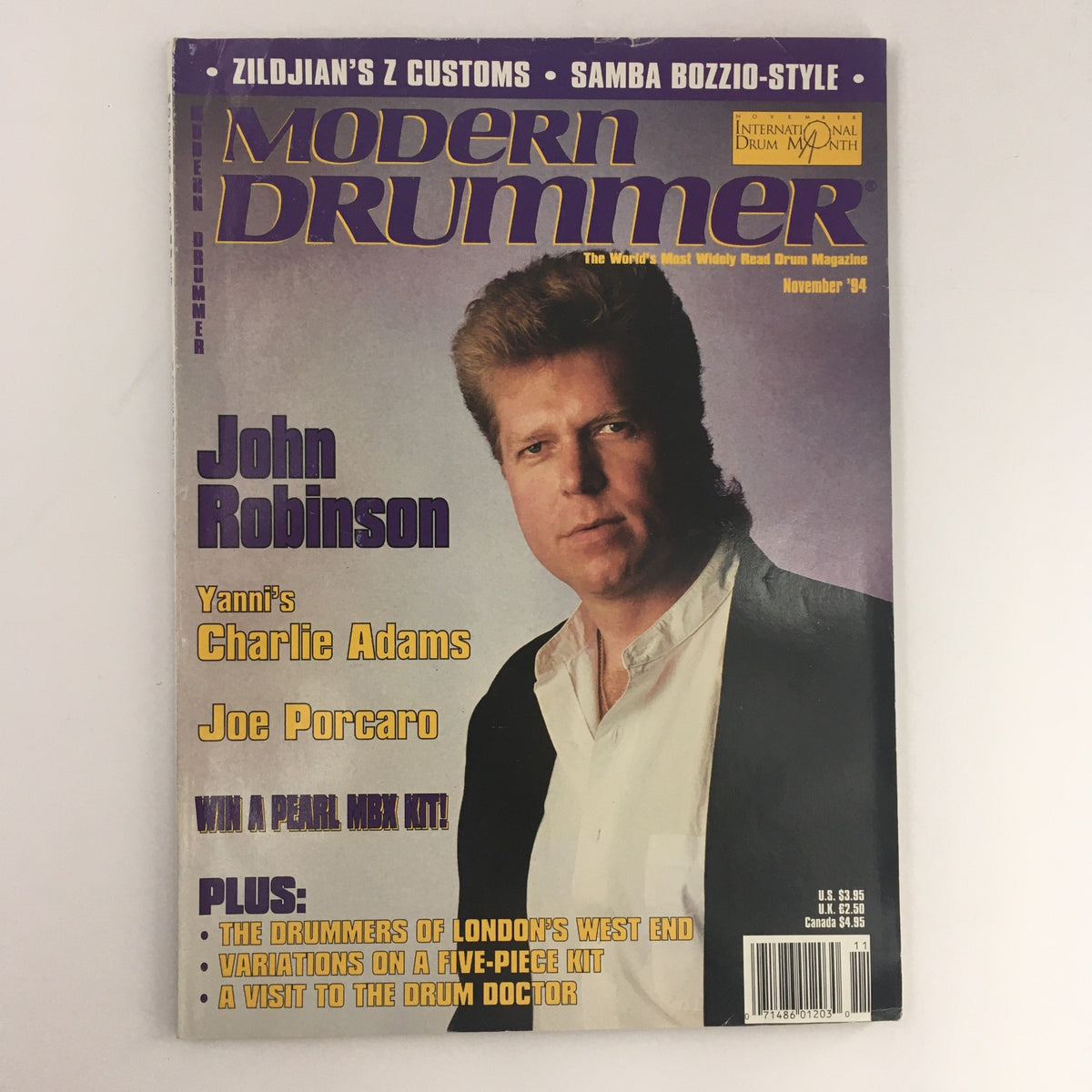 Cover of Modern Drummer Magazine, November 1994 edition featuring articles and insights from notable drummers John Robinson, Charlie Adams, and Joe Porcaro. The magazine highlights drumming techniques, interviews, and the vibrant music scene of the 90s.