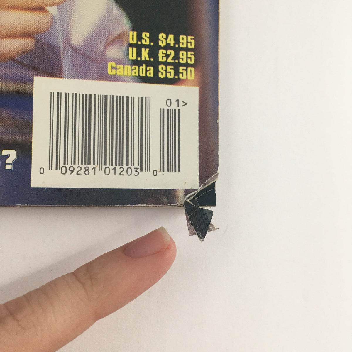 Close-up of the damaged corner and barcode of the Modern Drummer Magazine January 1999 issue, highlighting its vintage condition.