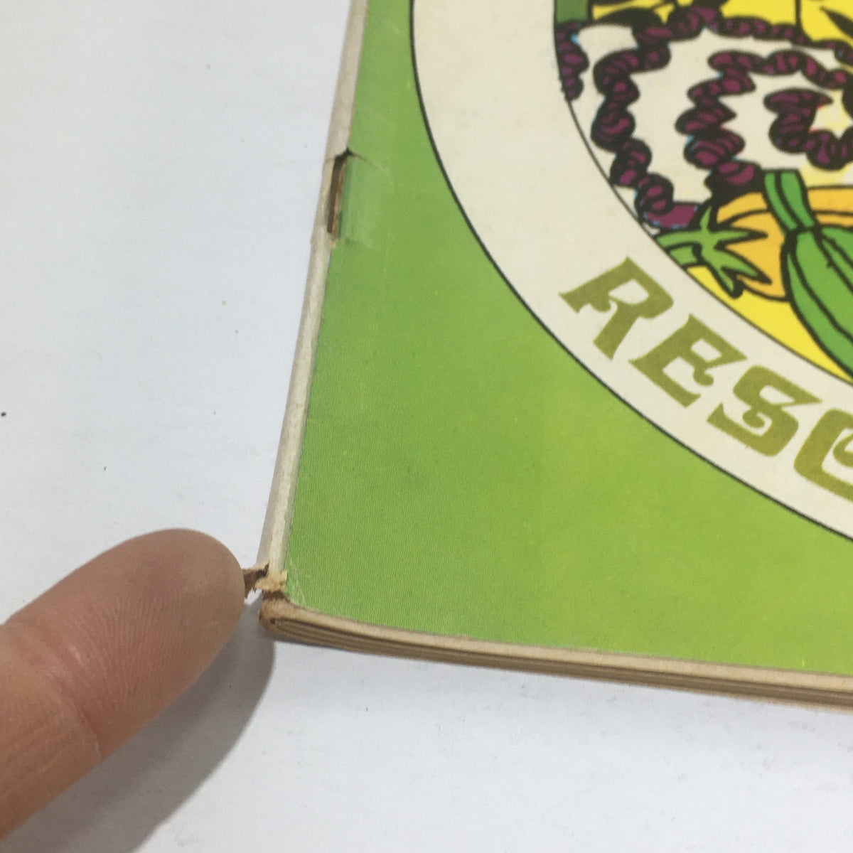 Close-up of a vintage magazine titled 'Cue Magazine: June 6 1970 - New Jersey and Pennsylvania: Resorts and Dining' showing edge wear and a tear on the binding.
