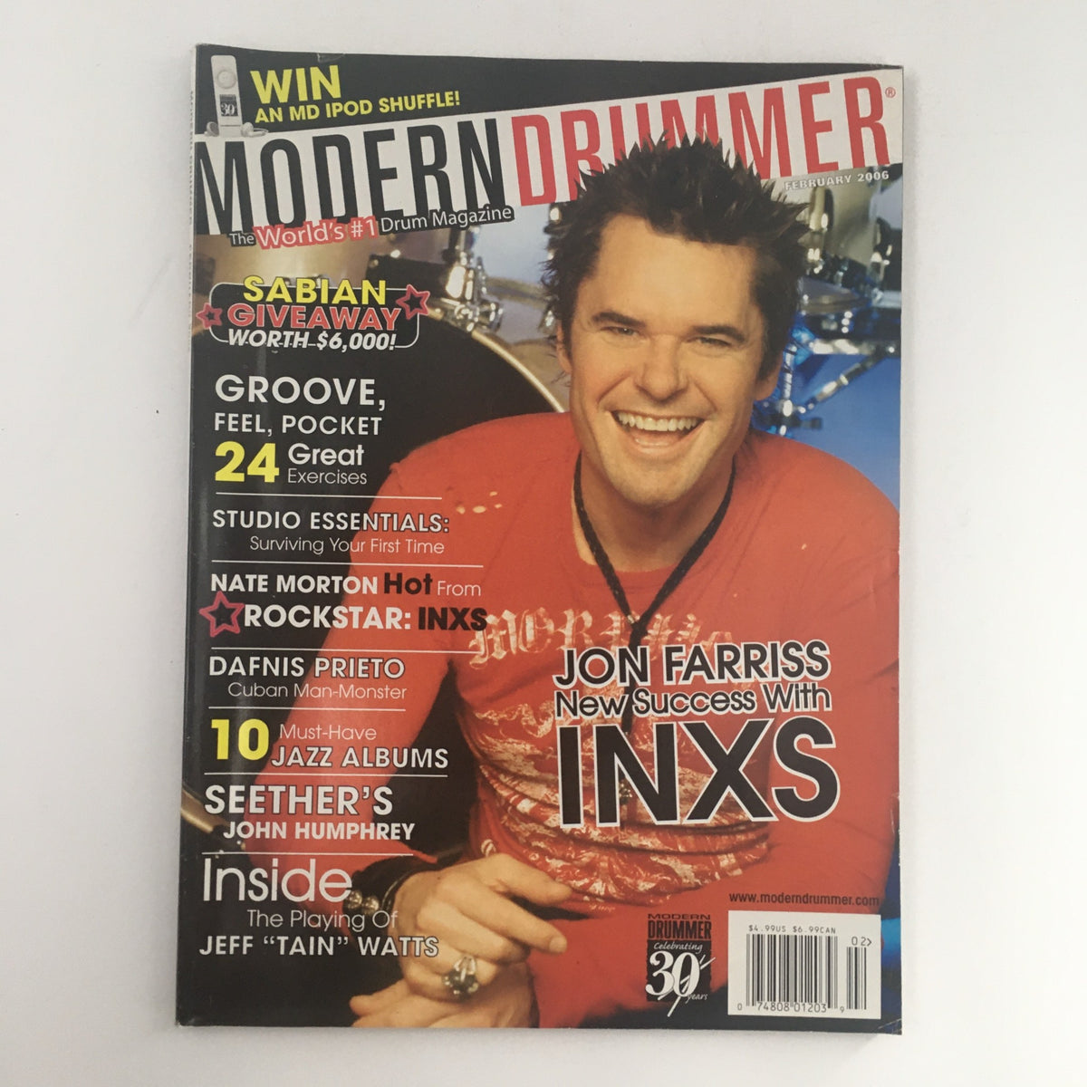 Modern Drummer Magazine February 2006 cover featuring Jon Farriss, Nate Morton, and Dafnis Prieto. This issue highlights exclusive interviews and insights from renowned drummers, showcasing trends in music and drumming techniques of the time.