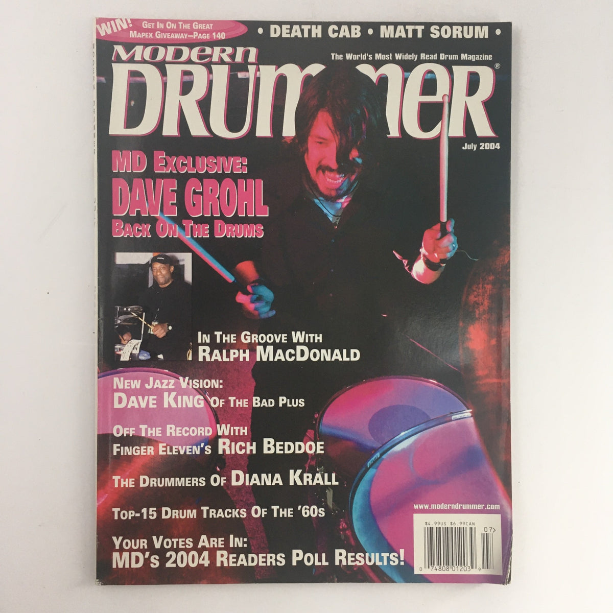 Modern Drummer Magazine July 2004 featuring Dave Grohl, Ralph MacDonald, and Dave King on the cover, showcasing a vibrant design with drums and images of the drummers.