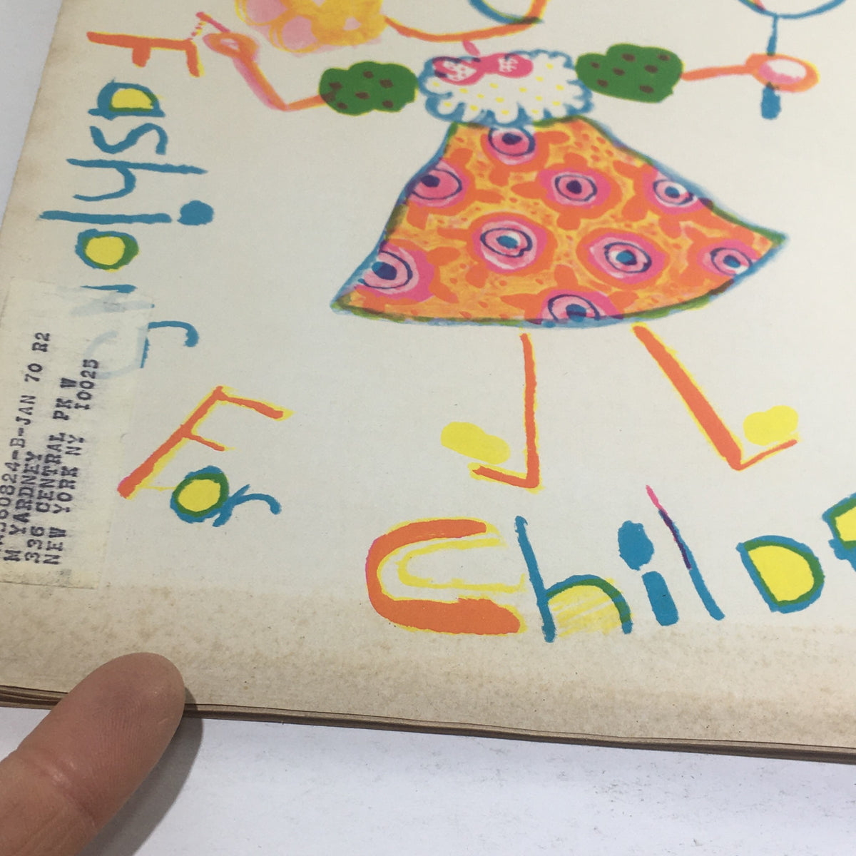 Close-up of Cue Magazine: February 15 1969 cover highlighting the artistic details of a child in fashion, with an address label adding character to the vintage magazine.