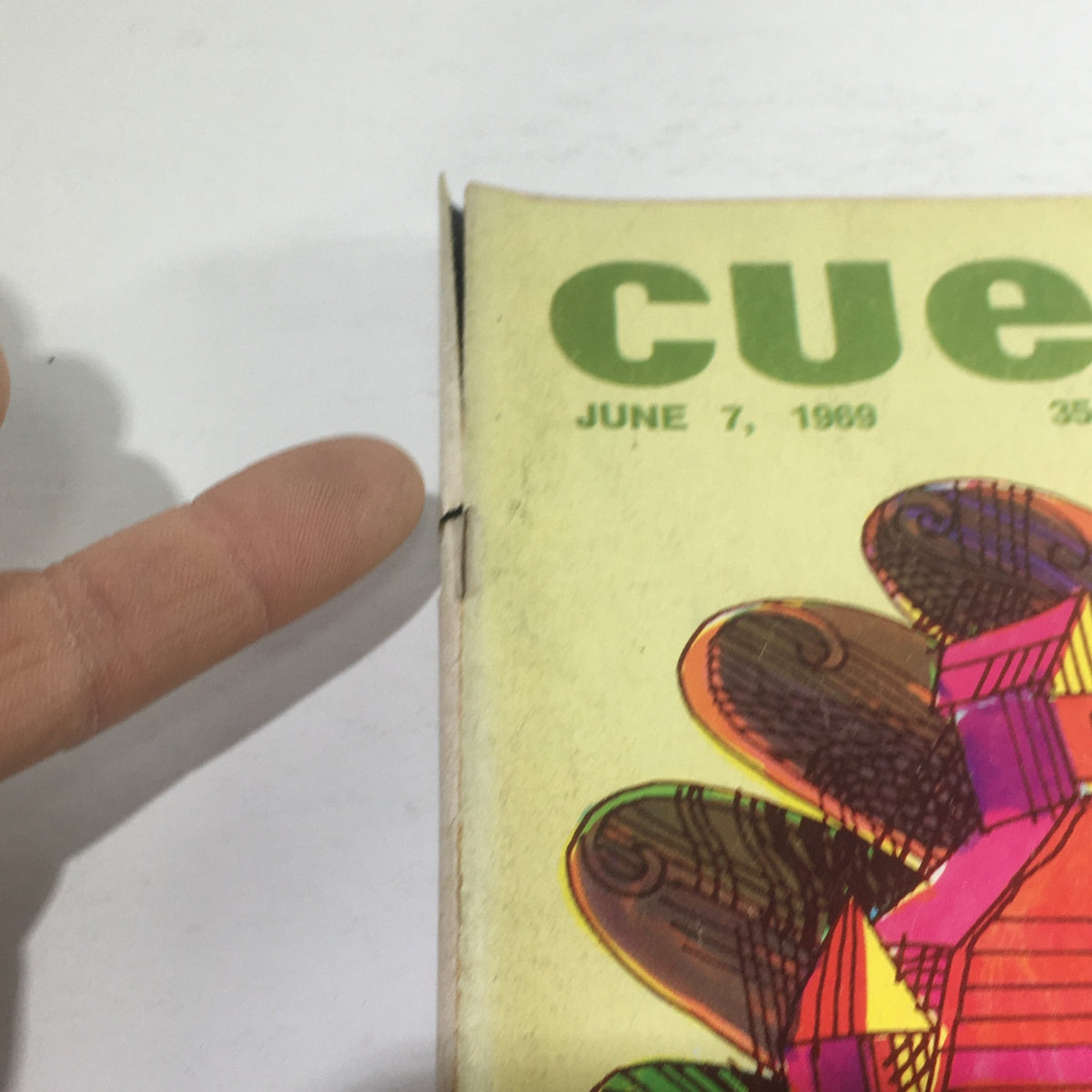 Close-up view of Cue Magazine: June 7, 1969 edition featuring vibrant theme cover art by Abe Gurvin, highlighting the magazine's title and date.