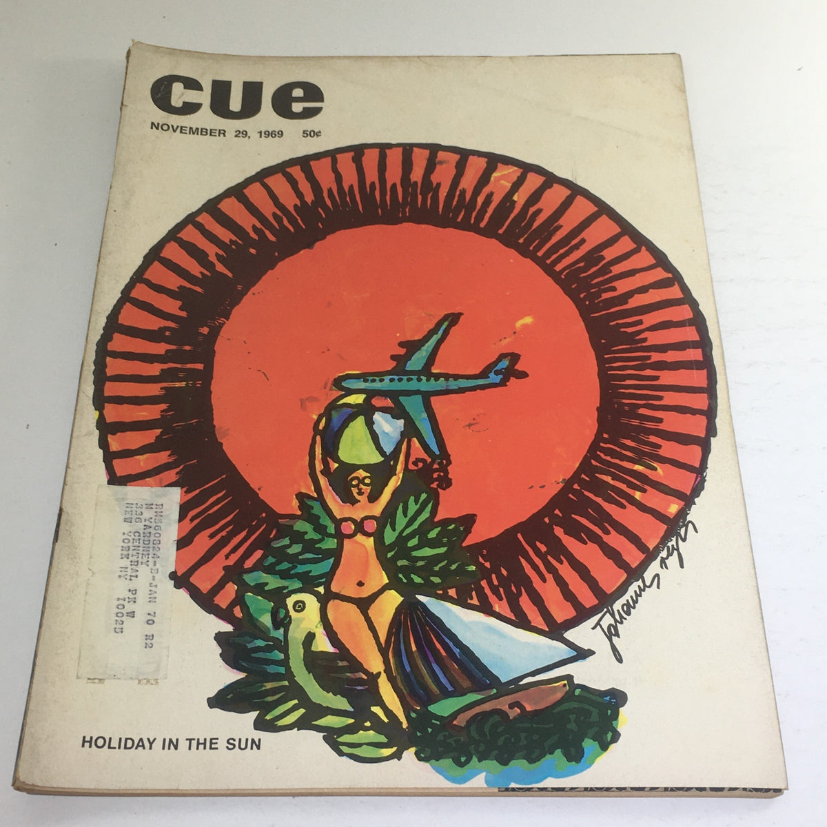 Cover of Cue Magazine, November 29, 1969, featuring a vibrant 'Holiday In The Sun' theme with artistic depictions of a woman in a swimsuit, an airplane, and tropical elements, highlighting the magazine's vintage charm.