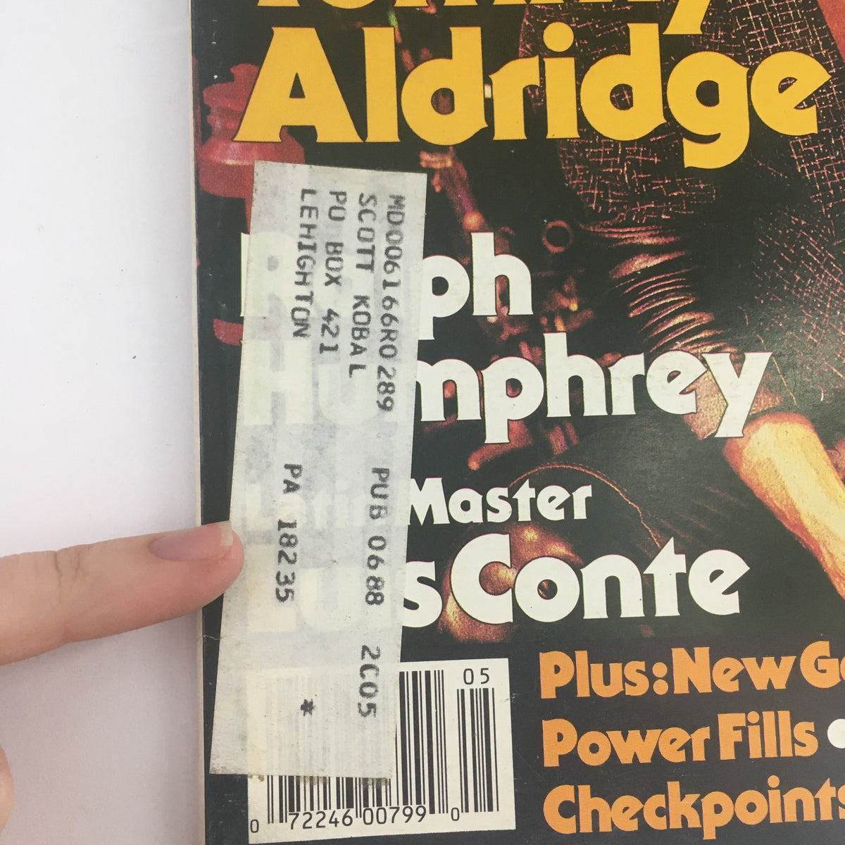 Close-up of the cover of Modern Drummer Magazine June 1988, displaying Tommy Aldridge, Ralph Humphrey, and Luis Conte. The image also features a visible address label on the side.