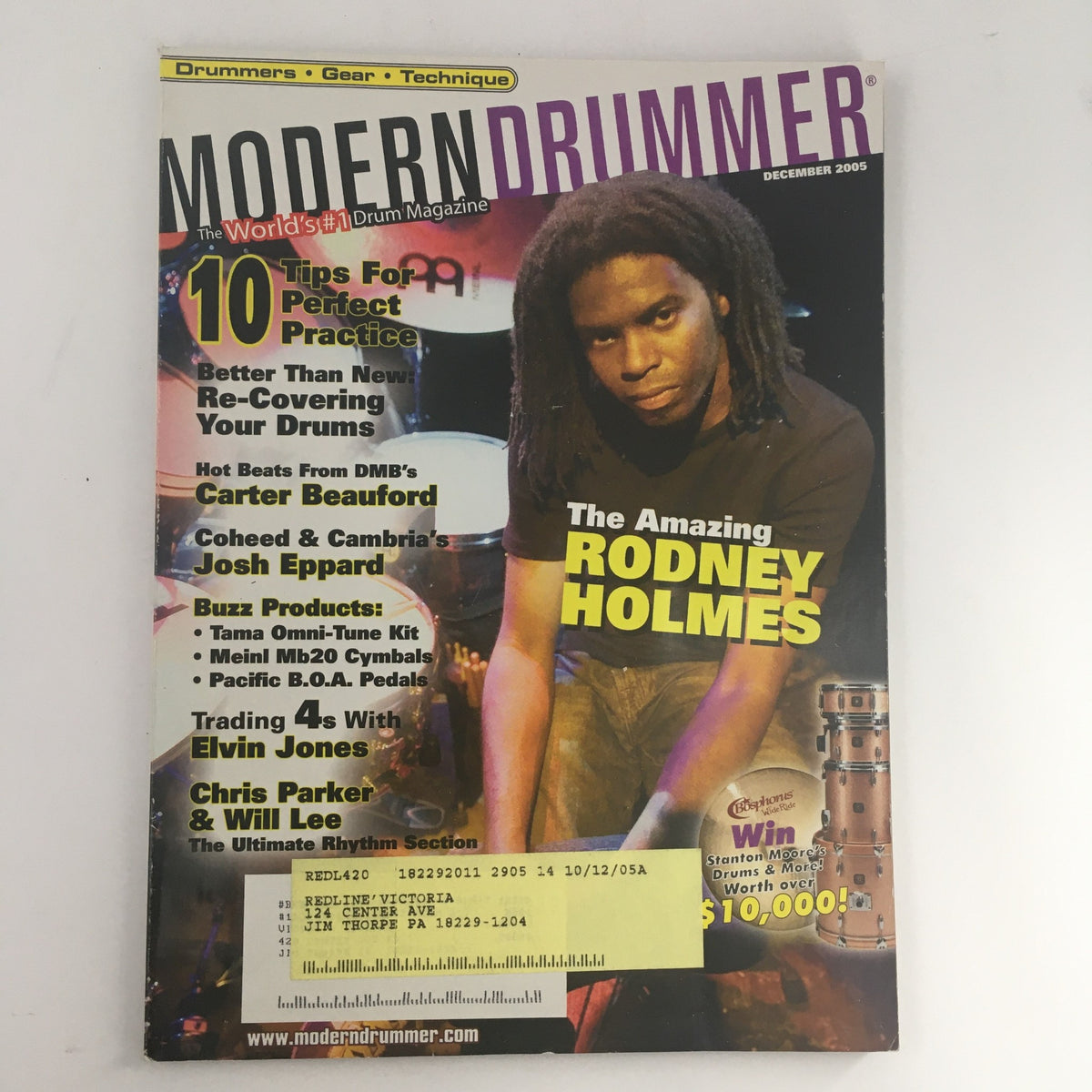 Modern Drummer Magazine cover from December 2005 featuring drummers Rodney Holmes, Carter Beauford, and Josh E. with tips for perfect practice and insights into the drumming world.