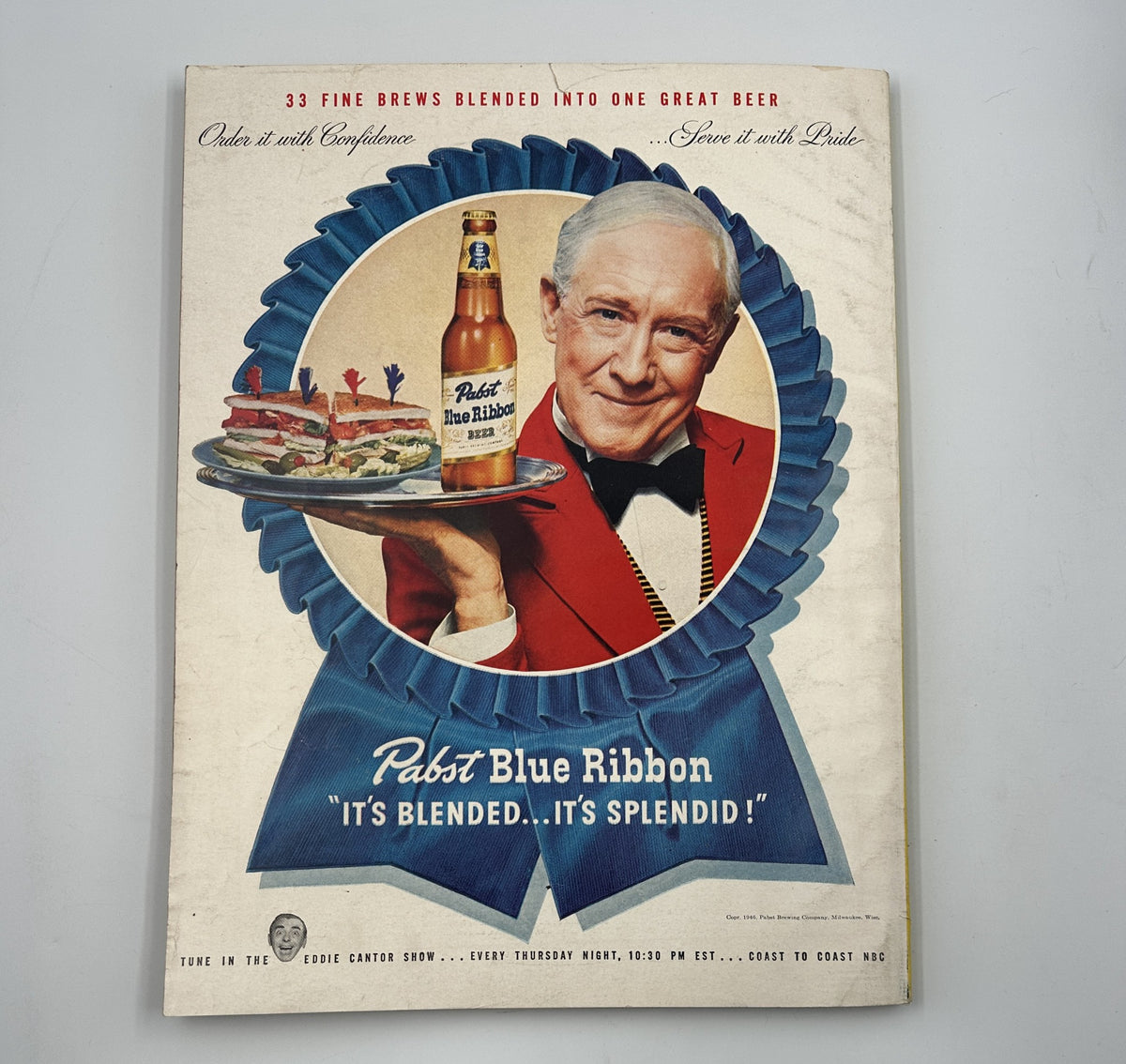 Esquire Magazine November 1946 advertisement featuring Pabst Blue Ribbon, displaying a man in a tuxedo holding a tray with beer and food, promoting the brand with the tagline 'It's Blended... It's Splendid!'