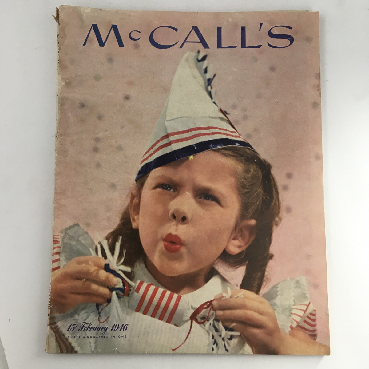 McCall's Magazine February 1946 Cover featuring a young girl in a striped hat, exuberantly blowing into a whistle. Illustrated by Pruett Carter.