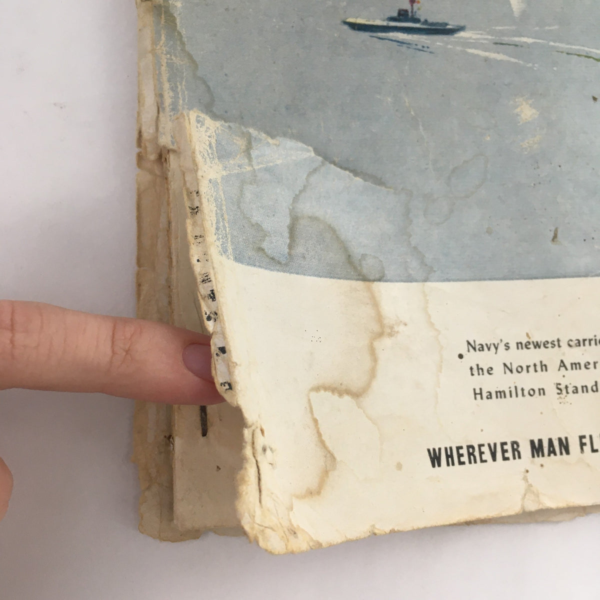 Side view of the Aero Digest magazine from July 1949 showing wear and tear, emphasizing its vintage condition and highlighting the text about the North American A-1 and Hamilton Standard.