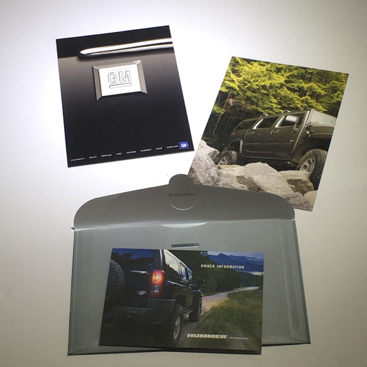 2008 Hummer H3 SUV Dealership Car Auto Brochure Catalog displayed with GM logo, featuring scenic images and owner information, presented in a gray folder.