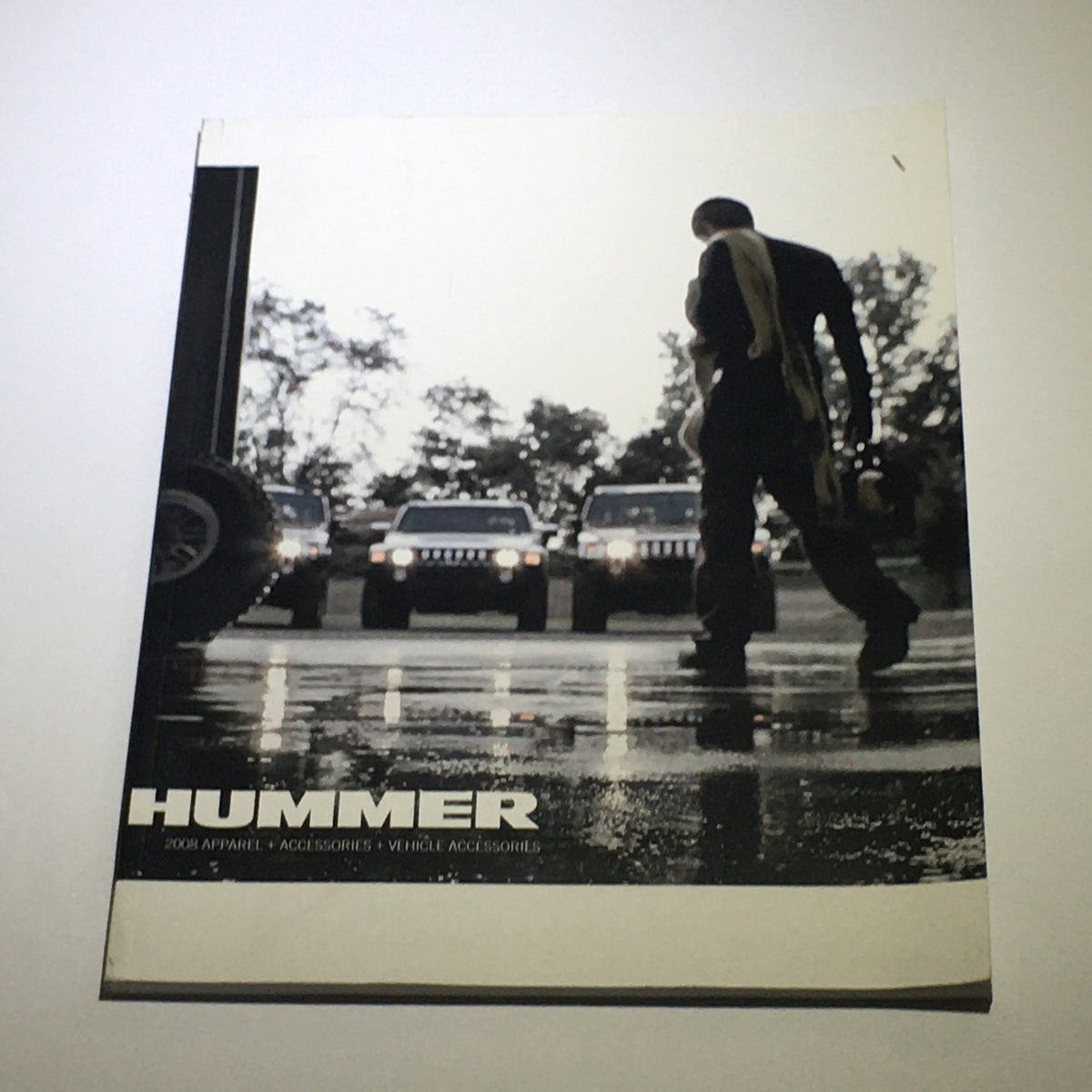 Cover of the 2008 Hummer Apparel+Vehicle Accessories Dealership Car Auto Brochure Catalog featuring a silhouette of a person in front of Hummer vehicles, capturing rugged luxury and adventure.