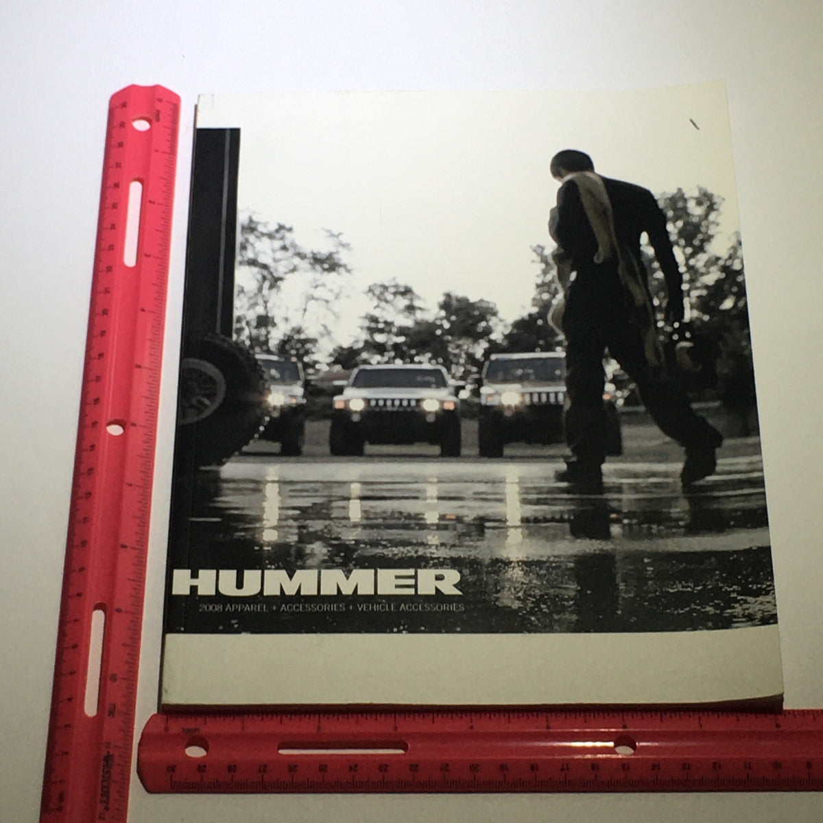 Front cover of the 2008 Hummer Apparel+Vehicle Accessories Dealership Car Auto Brochure Catalog showing a man with Hummers in the background.