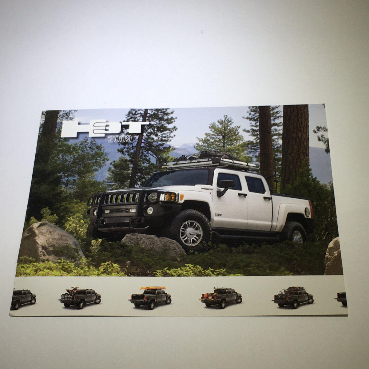 2009 Hummer H3T Exterior Color Chooser Dealership Car Auto Brochure Catalog showcasing the Hummer H3T parked in a forest setting with rocks in the foreground.