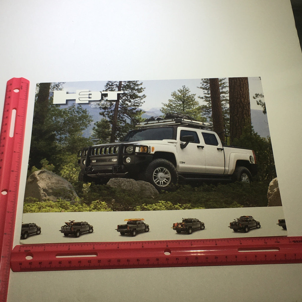2009 Hummer H3T Exterior Color Chooser Dealership Car Auto Brochure Catalog displayed outdoors with a white Hummer H3T parked on rocky terrain for effective color selection.