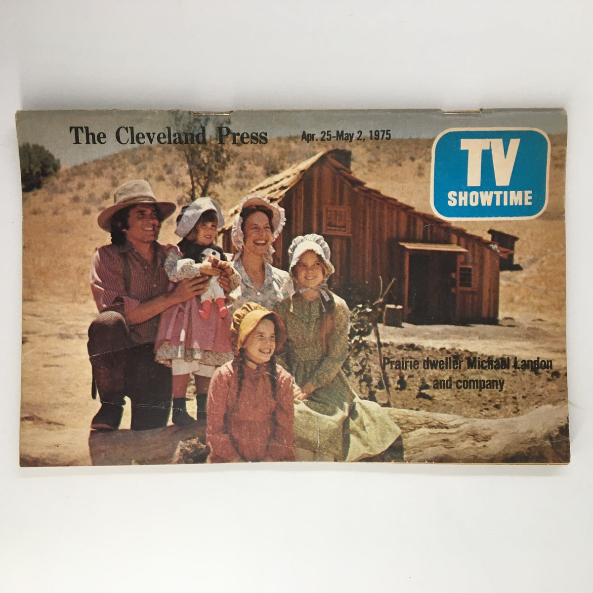 Cover of The Cleveland Press TV Showtime Guide from April 25, 1975, featuring a group of women and children in prairie attire, showcasing Michael Landon and company, set against a rustic backdrop.