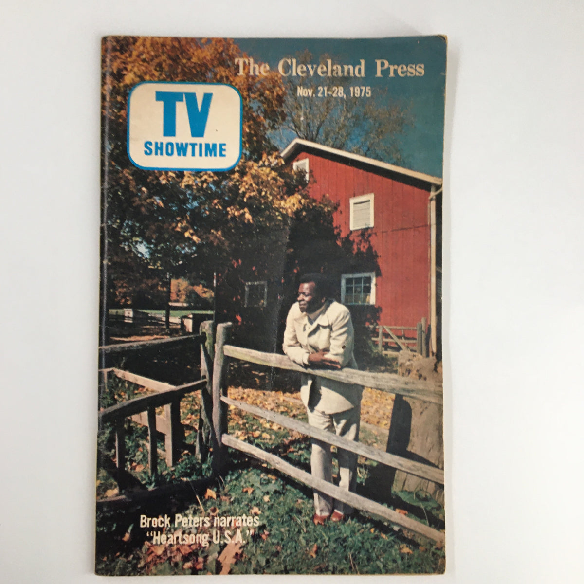 Cover of The Cleveland Press TV Showtime Guide November 1975 featuring Brock Peters leaning on a wooden fence with a fall landscape in the background. This vintage magazine features TV listings and cultural insights from the 1970s.