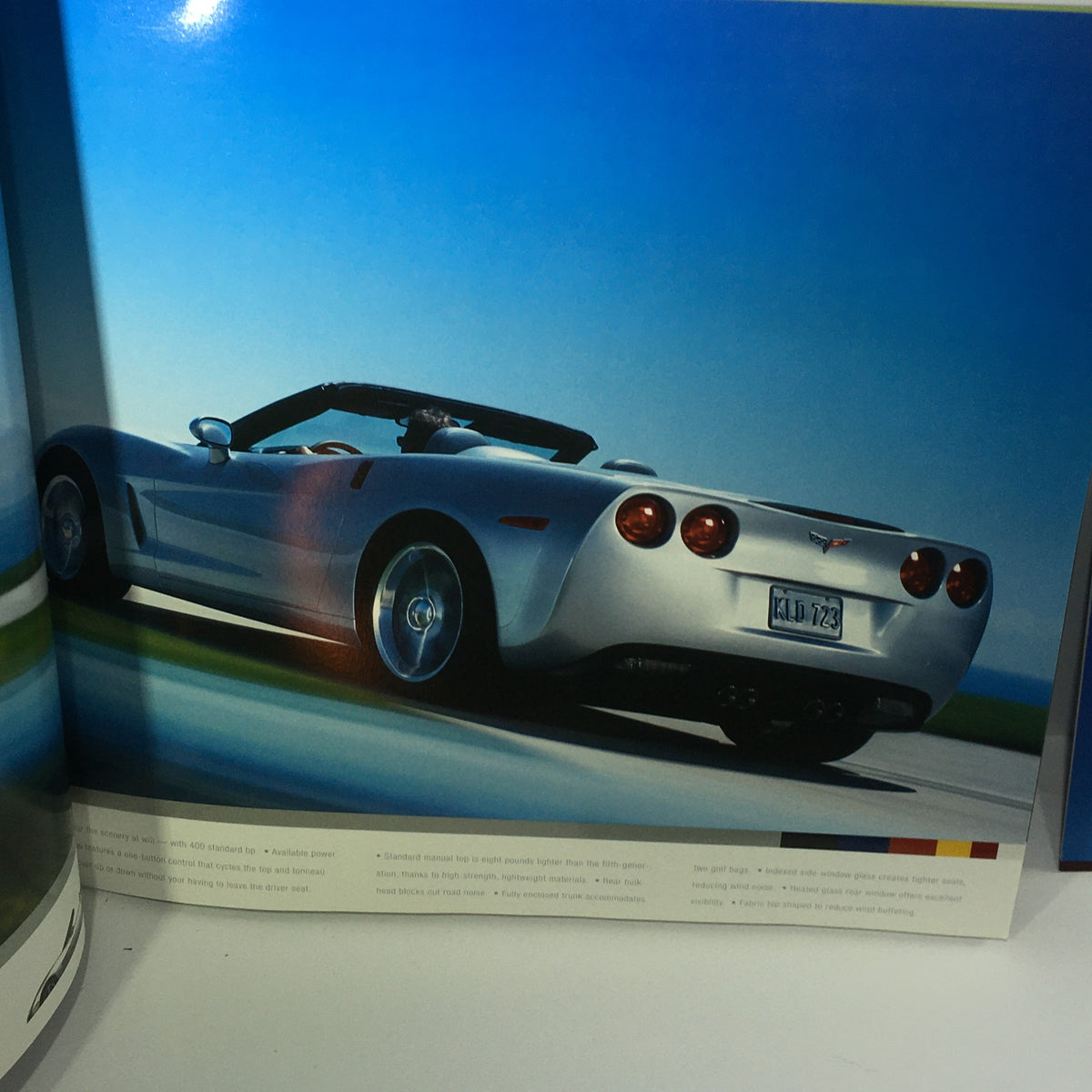 Interior view of the 2006 Chevrolet Corvette HP 505 Accessories Brochure displaying a silver convertible Corvette on a road.