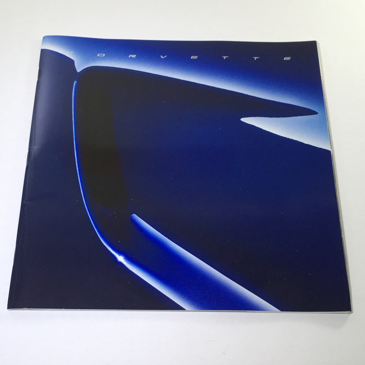 2004 Chevrolet Corvette Dealership Car Auto Brochure Catalog cover showcasing a sleek design with a modern silhouette.