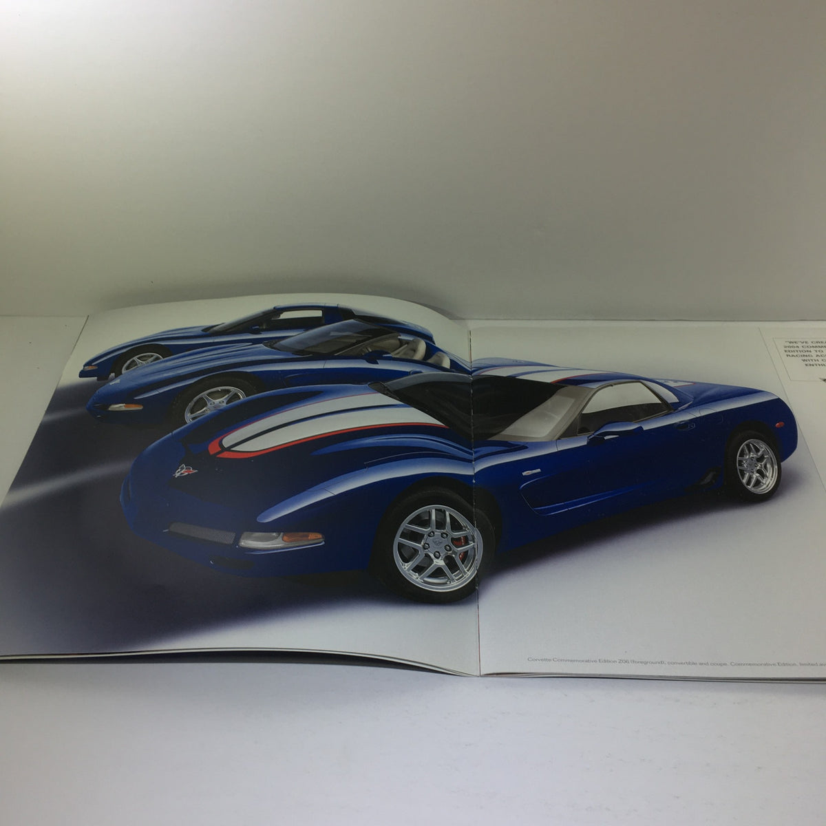 Interior layout of the 2004 Chevrolet Corvette brochure featuring images of blue Corvettes in a dynamic arrangement.