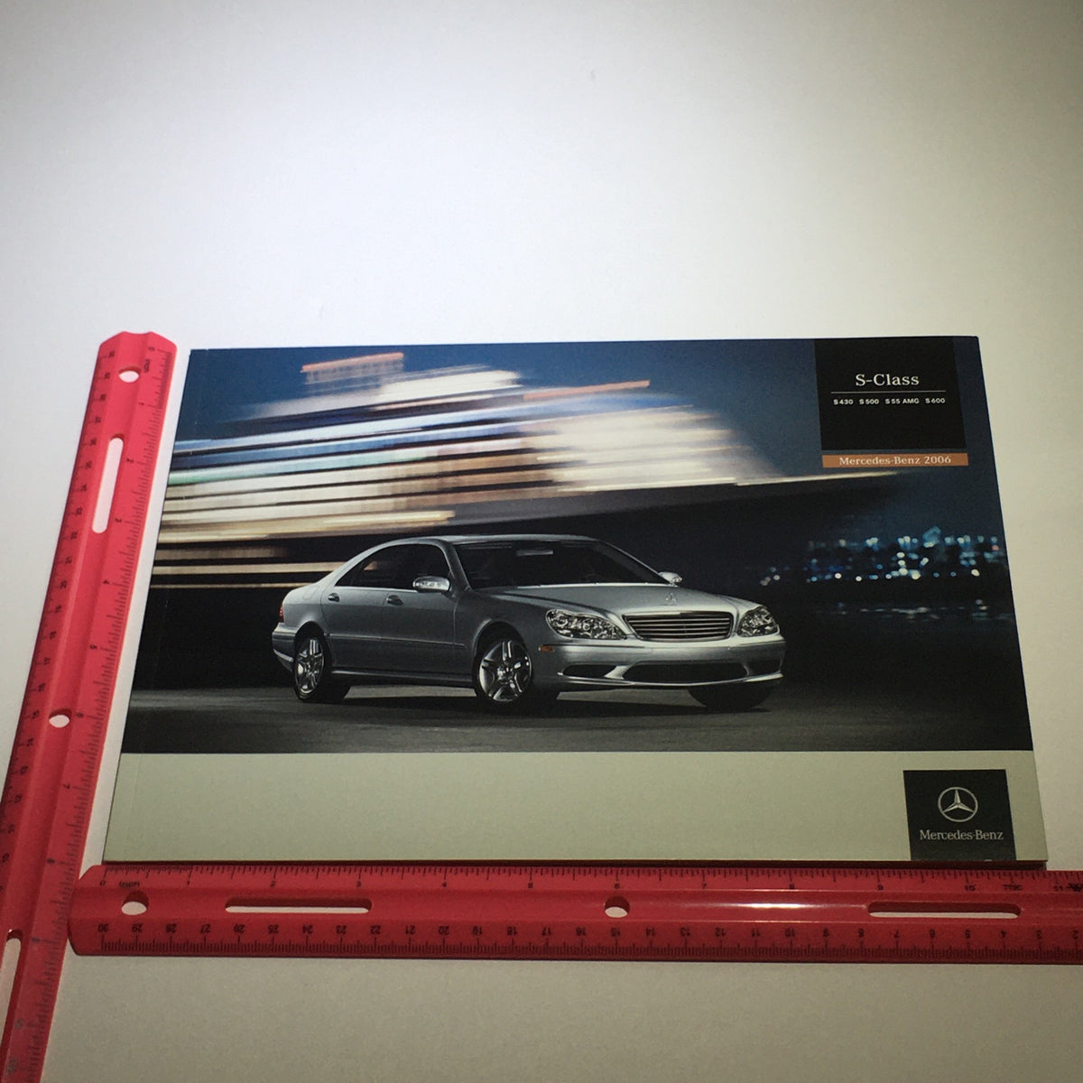 Front view of a silver Mercedes-Benz S-Class highlighted in the 2006 catalog with a blurred background.