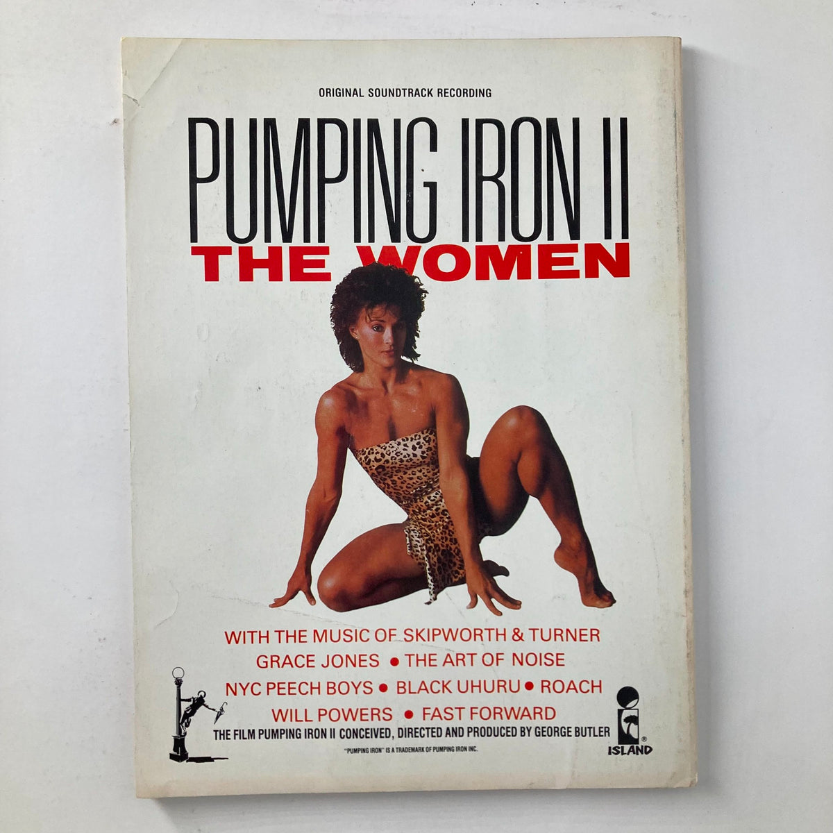 Cover of the soundtrack album Pumping Iron II: The Women, featuring a female model emphasizing fitness and strength, related to the bodybuilding culture of the 1980s.