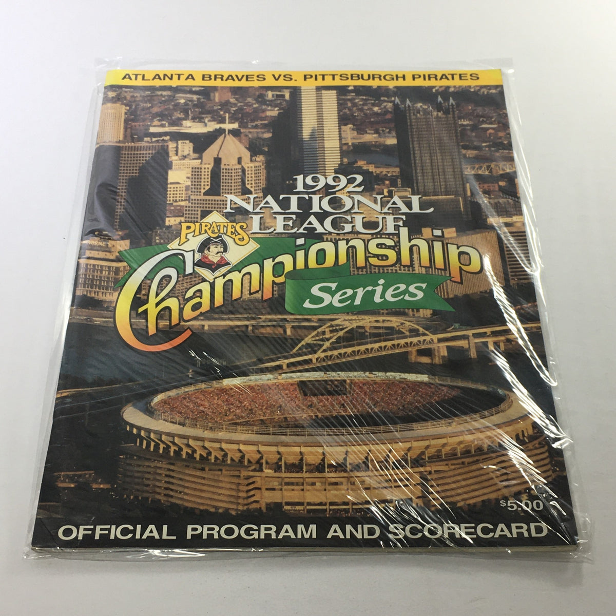 1992 National League Championship Series official program and scorecard featuring Atlanta Braves vs Pittsburgh Pirates, presented in plastic protective covering.