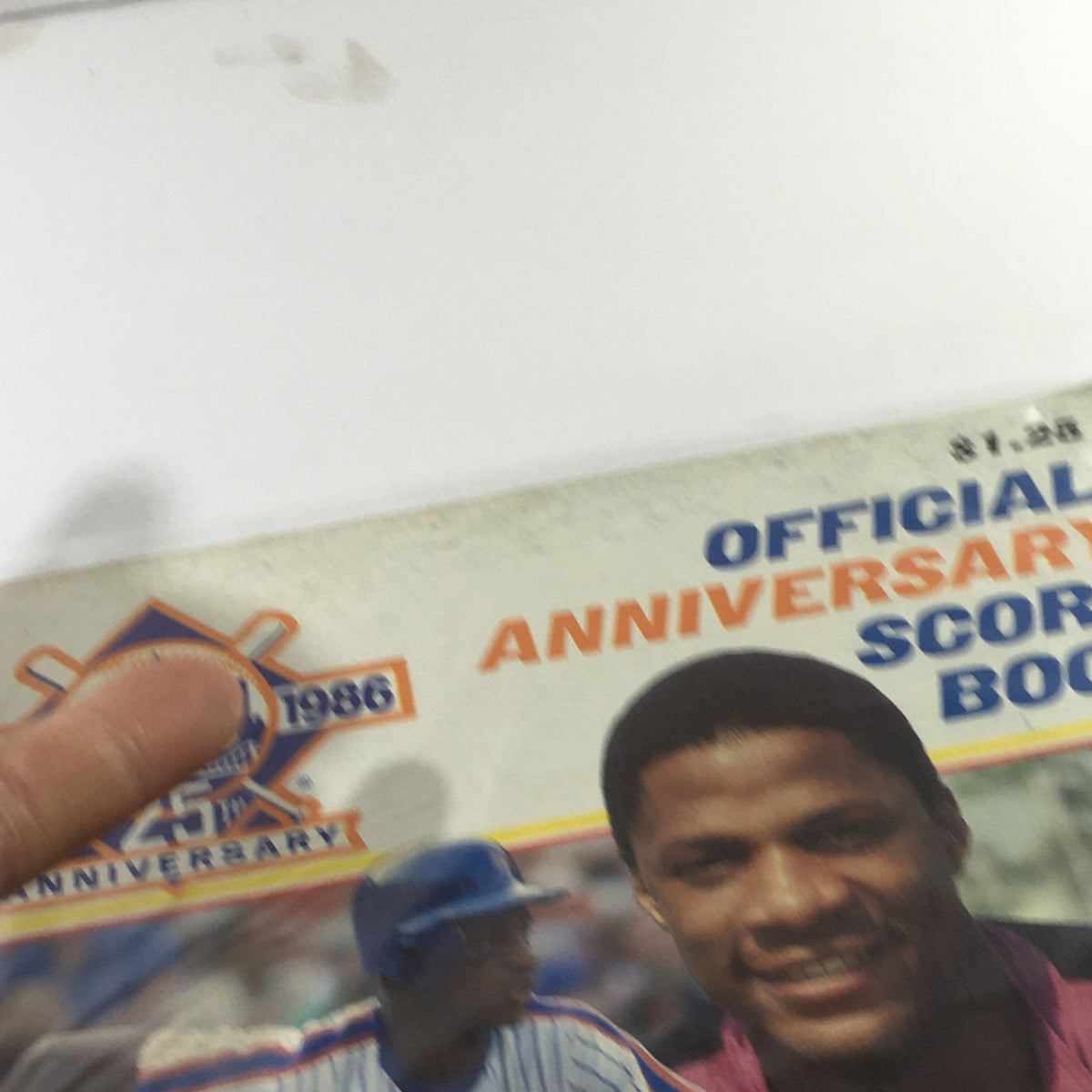 Close-up of the 1962-1986 New York Mets Official Score Book 25th Anniversary featuring Darryl Strawberry, highlighting the scorebook's design and the player's image.