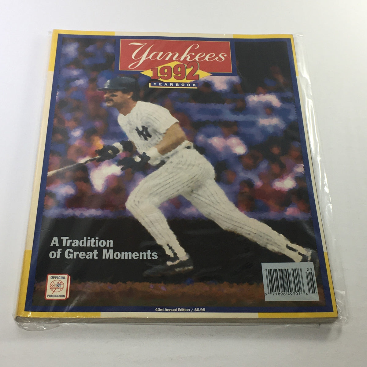 1992 New York Yankees Official Yearbook cover showcasing a player in action, highlighting the theme 'A Tradition of Great Moments', with protective plastic covering.