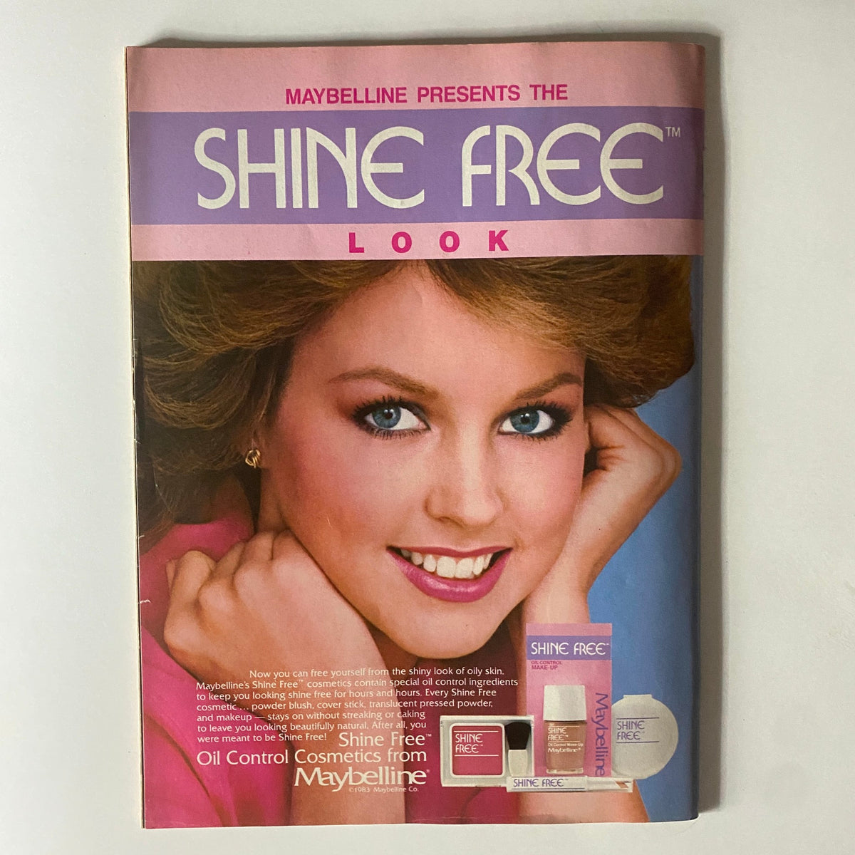 Vintage advertisement for Maybelline's Shine Free cosmetics, featured in Tiger Beat Magazine February 1984, highlighting beauty trends of the 1980s with a model showcasing flawless skin.