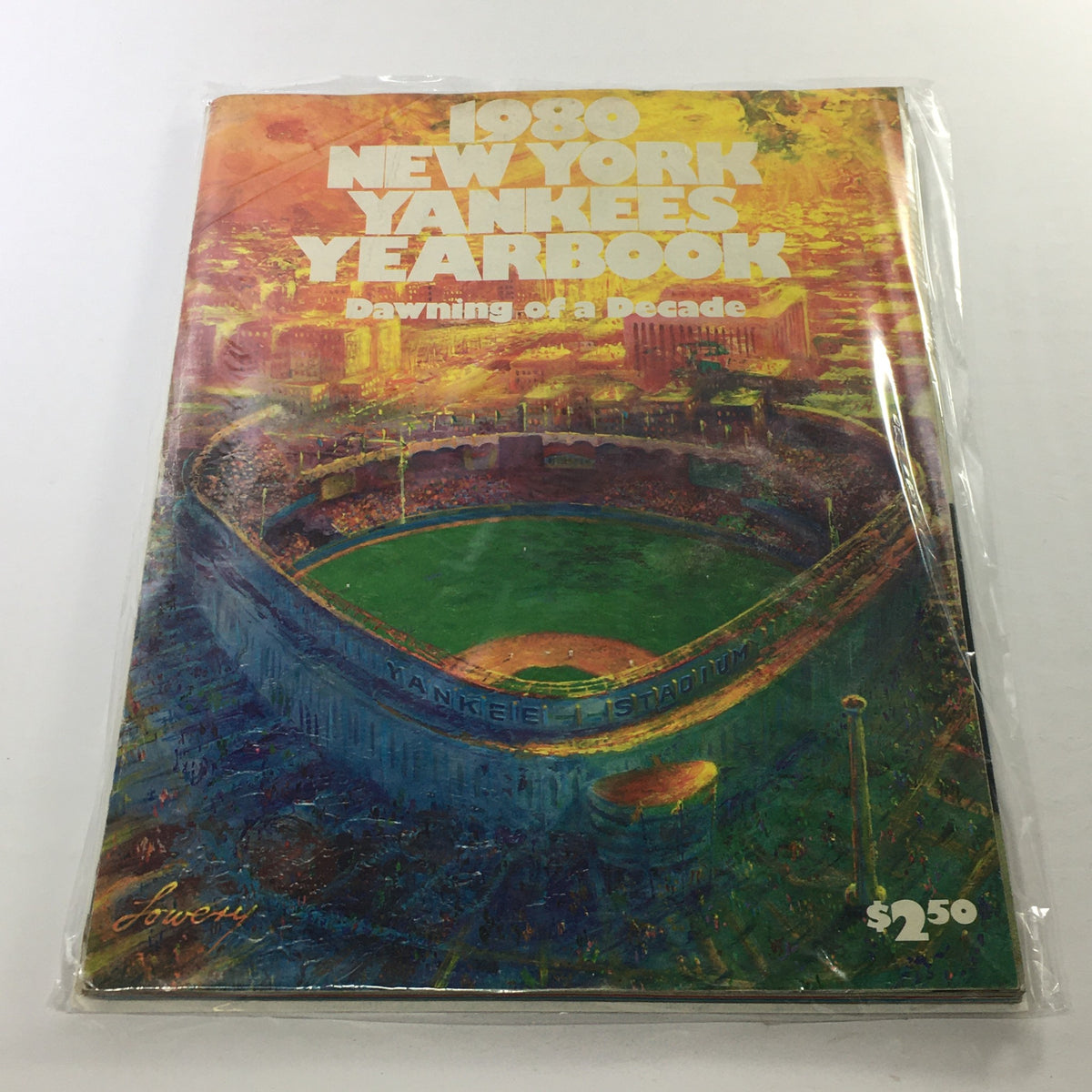 1980 New York Yankees Yearbook: Dawning Of A Decade cover featuring Yankee Stadium, vibrant artwork, and protective plastic covering.