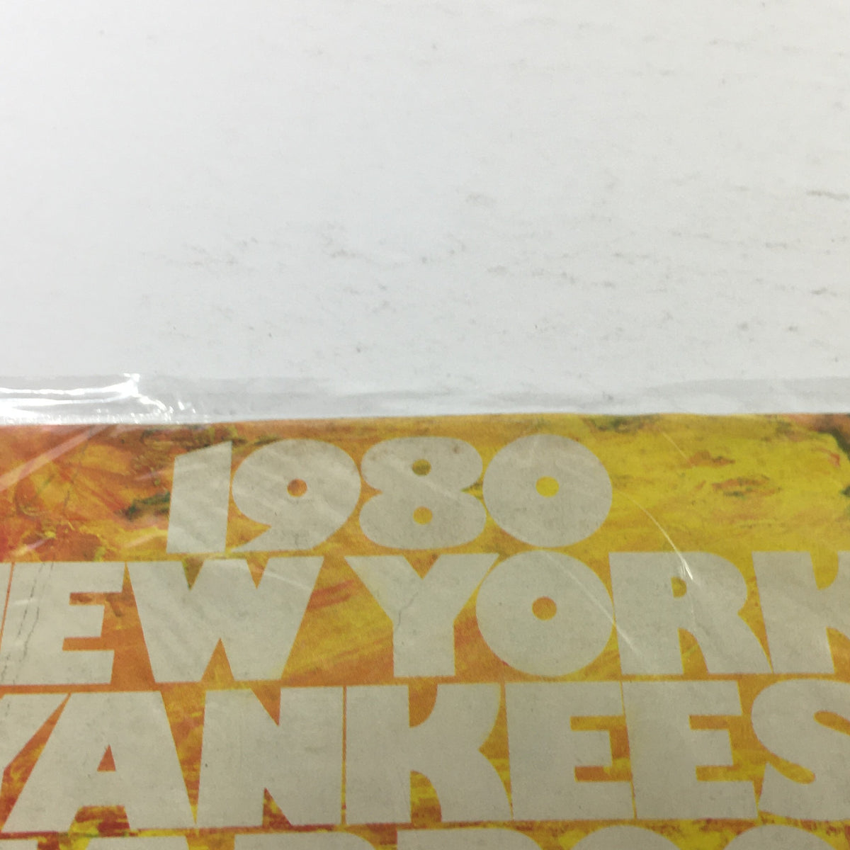 Close-up of the 1980 New York Yankees Yearbook: Dawning Of A Decade, showcasing the title and colorful design.