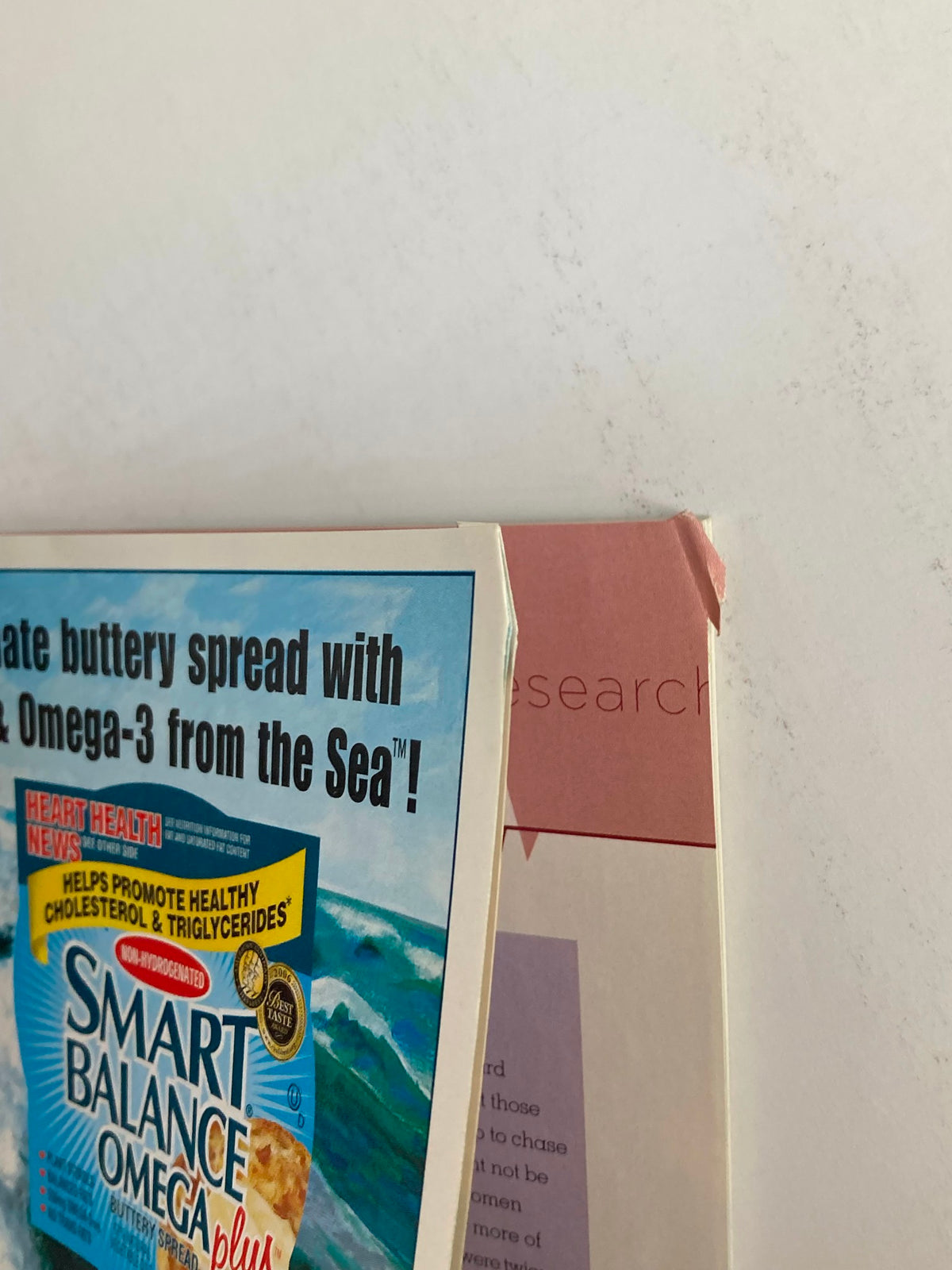 Close-up of a page from Better Homes & Gardens Magazine Spring 2006, displaying an advertisement for Smart Balance Omega-3 spread alongside a section title related to heart health research.