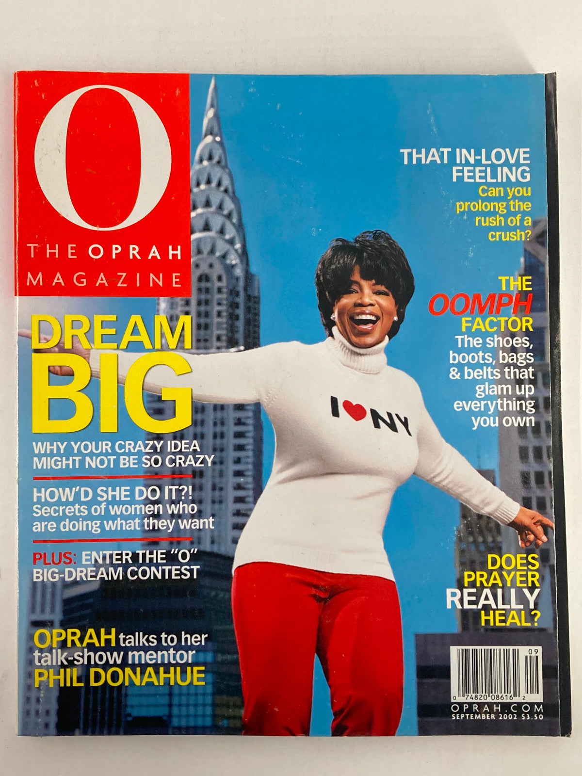 The Oprah Magazine September 2002 cover featuring Oprah Winfrey in a white sweater with 'I ♥ NY' text. The cover highlights an interview with Phil Donahue, the theme 'Dream Big,' and other features such as fashion and inspiration. A vintage collectible magazine showcasing Oprah's influence on media and mentorship.