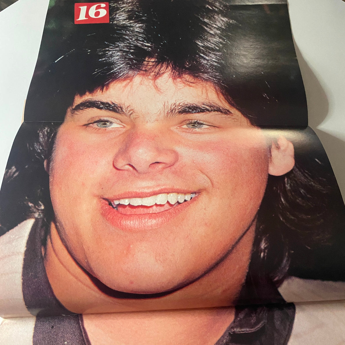 A vibrant image of a smiling young male star featured in 16 Magazine January 1984, highlighting the exuberance of '80s youth culture.